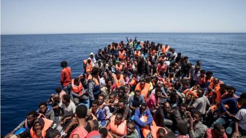 Migrants crowd the deck of their wooden boat off the coast of Libya May 14, 2015