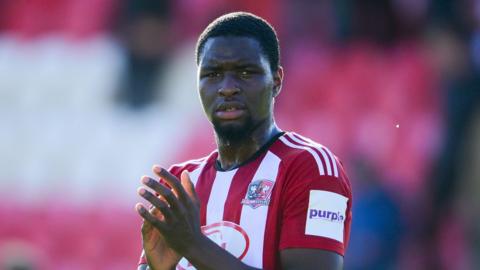 Cheick Diabate applauds fans after a game