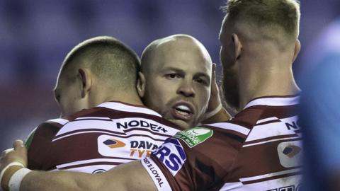 Liam Marshall is congratulated by his Wigan Warriors team