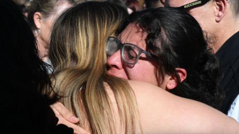 Friends of the victims cry at school vigil