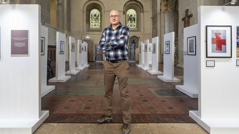 Jonathan Banks with his exhibition in St Albans Cathedral