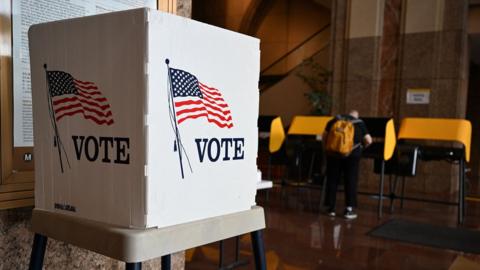 A voter prepares their ballot at a polling station during early voting ahead of the US midterm elections in Los Angeles, California, on November 1, 2022