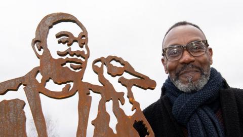 Sir Lenny Henry with sculpture