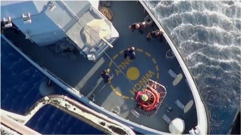 Migrant winched into helicopter from rescue boat