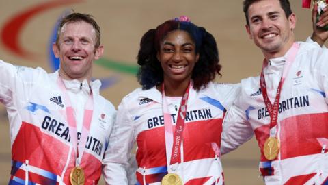 Jody Cundy, Kadeena Cox and JAco van Gass celebrate Britain's cycling team pursuit gold at the Tokyo Paralympics