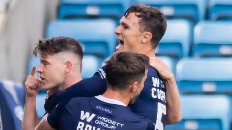 Kevin Nisbet celebrates his goal for Millwall with two of his team-mates