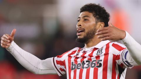 Josh Laurent gestures to Stoke team-mates during a game