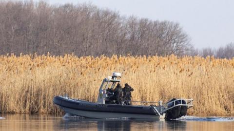 Police search the marshland where bodies were found in Akwesasne, Quebec, Canada March 31, 2023.