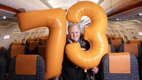 Pam Clark holding birthday balloons