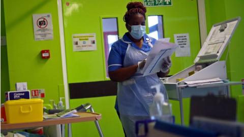 A nurse wears a face mask in Blackburn in May