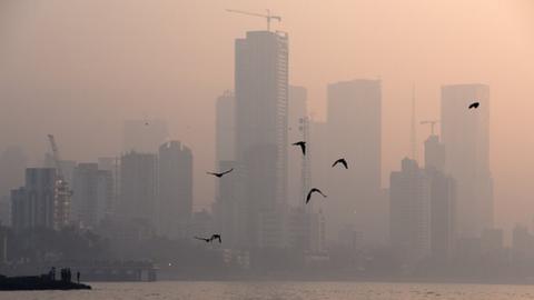 Highrise buildings are seen partially through dense smog in Mumbai, India, 18 January, 2023.