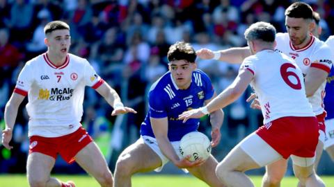 Cavan's Oisin Brady is surrounded by Tyrone trio Niall Devlin, Mattie Donnelly and Padraig Hampsey