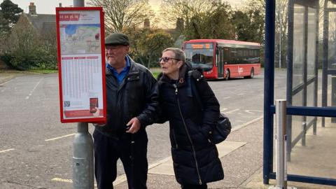 Hunstanton bus station with two people looking at a timetable