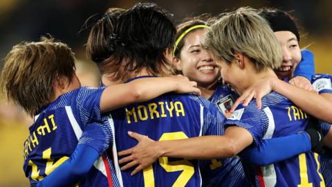 Japan's players celebrate scoring against Spain at the Women's World Cup