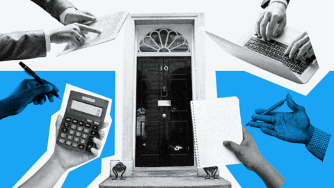 Downing street door with laptops and notebooks laid over the top