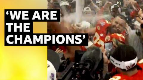 Travis Kelce sprays champagne in the changing rooms