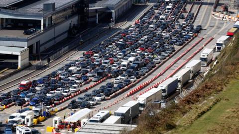 Vehicles wait to check-in ahead of departure on ferries at the Port of Dover in Dover on Friday 7 April 2023