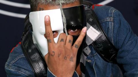 XXXTentacion wearing a half black, half white mask