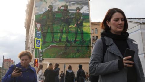 A giant pro-war mural showing three soldiers in camouflage with weapons, emblazoned with the words "For Russia" with the letter "Z", is seen is seen on September 22, 2022, in Moscow, Russia.