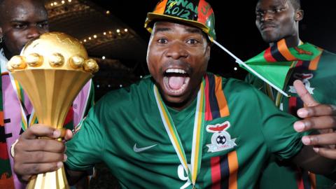 Collins Mbesuma celebrates with the Afcon trophy after Zambia won the title in 2012
