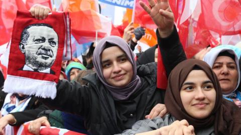 Supporters of Turkish President Erdogan wave flags during the AK Party's election campaign rally in Ankara, Turkey, 23 March 2024