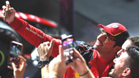 Carlos Sainz celebrates with Ferrari team