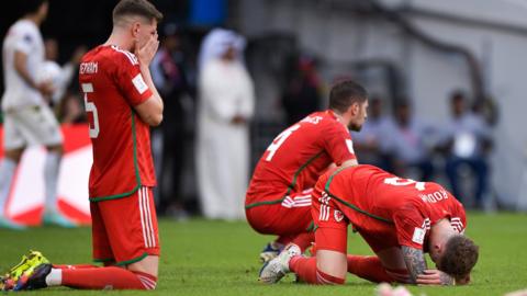 Wales players sink to the ground