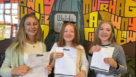 Three girls with their results at Ysgol Bro Preseli