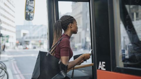 Woman boarding bus