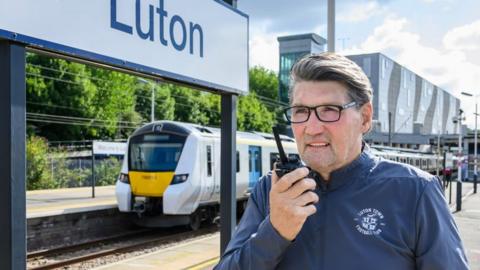 Mick Harford recording an announcement at Luton train station