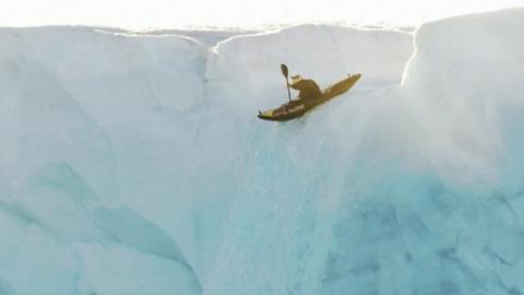 Aniol Serrasolses going down an ice waterfall in a kayak