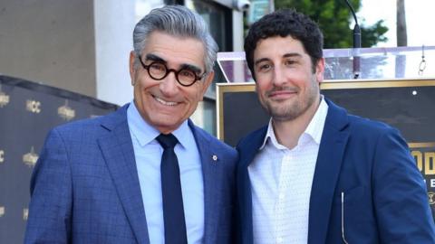 Canadian actor and comedian Eugene Levy (L) poses with US actor Jason Biggs during a ceremony honoring Levy with a star on the Hollywood Walk of Fame in Los Angeles, California,