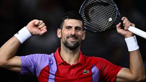 Novak Djokovic raises his fists in celebration at the Paris Masters