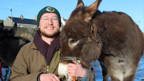 Robert Wallace with a donkey at Kinedale Donkeys