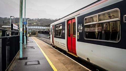 Transport for Wales train stopped at a rail platform