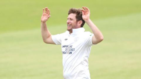 Liam Dawson celebrates a wicket