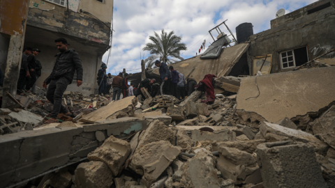 Residents searching destroyed buildings in southern Gaza on Sunday