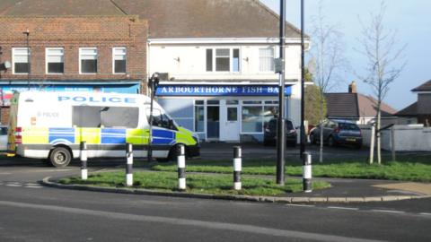 Police van in front of shops