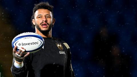 Courtney Lawes holds the ball as he warms up for Northampton Saints