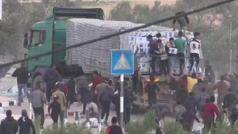 Crowds board aid trucks at Rafah Crossing