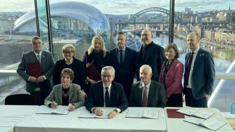 Michael Gove signing the deal in Gateshead