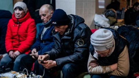 People sit in a humanitarian aid centre in Bakhmut, Ukraine