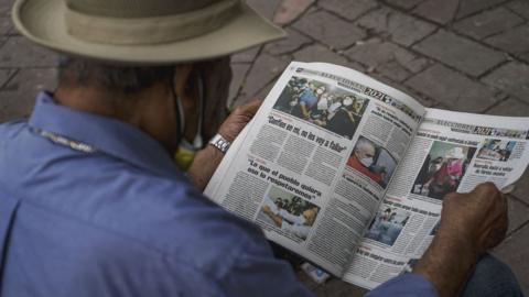 A man reads a local newspaper on 29 November 2021 in Tegucigalpa, Honduras.