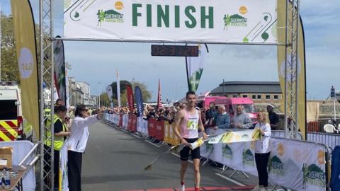 Guillaume Ruel crosses the finish line at the 2024 Guernsey Marathon