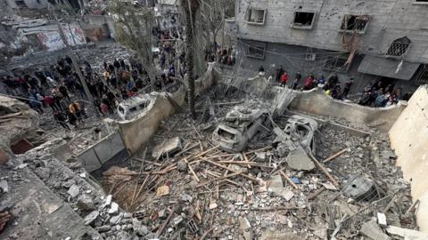 People inspect the site of an Israeli strike on a house in Jabalia, in the northern Gaza Strip, on Wednesday