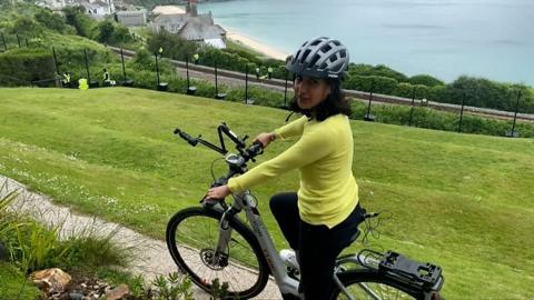 Nomia Iqbal cycling around Cornish G7 village
