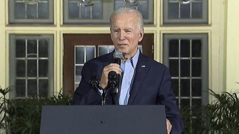 President Biden speaking on stage
