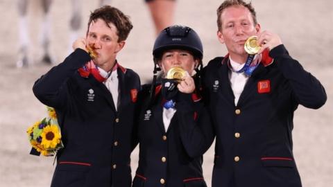 Gold medallists Oliver Townend of Britain, Laura Collett of Britain and Tom McEwen of Britain celebrate. REUTERS/Molly Darlington