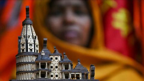A shopkeeper displays a model of the Hindu temple to Ram ahead of its inauguration ceremony in Ayodhya on December 29, 2023.