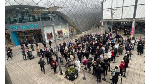 Shoppers queuing to get into a Primark store